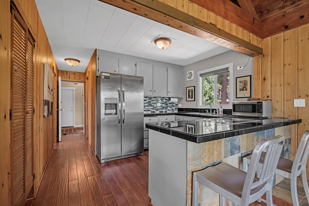 1753 Lightning Lane Arnold, CA 95223 - Photo 12 of 46 a kitchen with granite countertop a refrigerator and a stove top oven