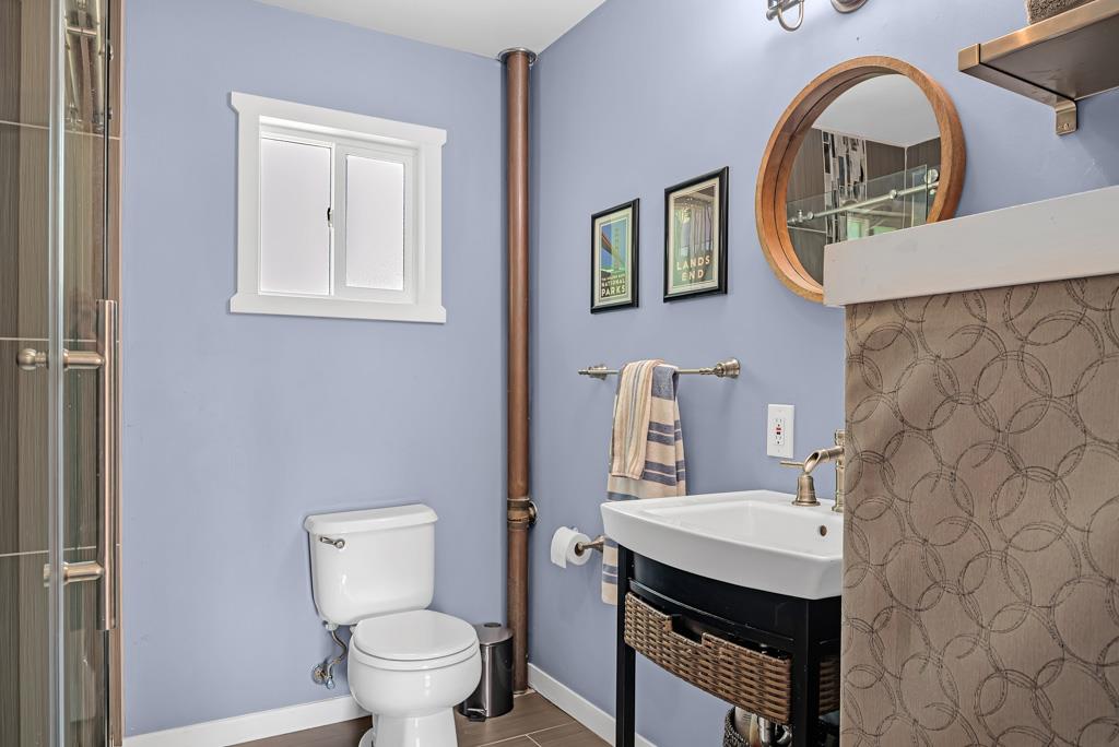 1753 Lightning Lane Arnold, CA 95223 - Photo 17 of 46 a bathroom with a sink a toilet and a mirror