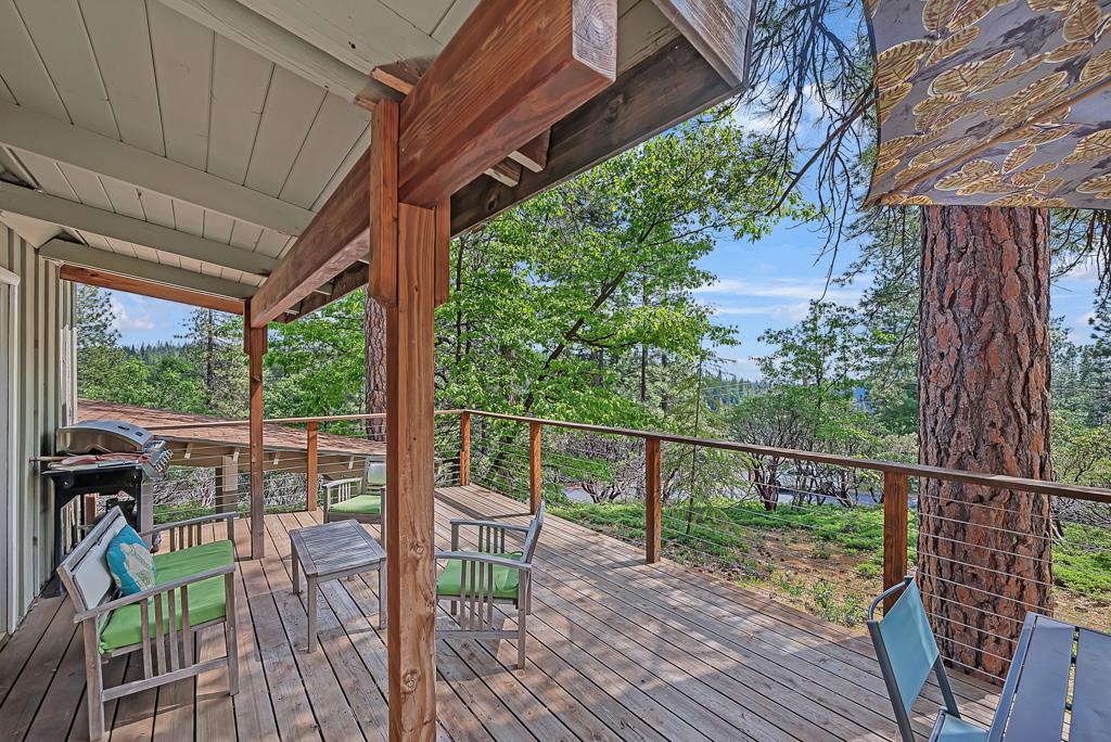1753 Lightning Lane Arnold, CA 95223 - Photo 25 of 46 a view of a balcony with chairs and wooden floor