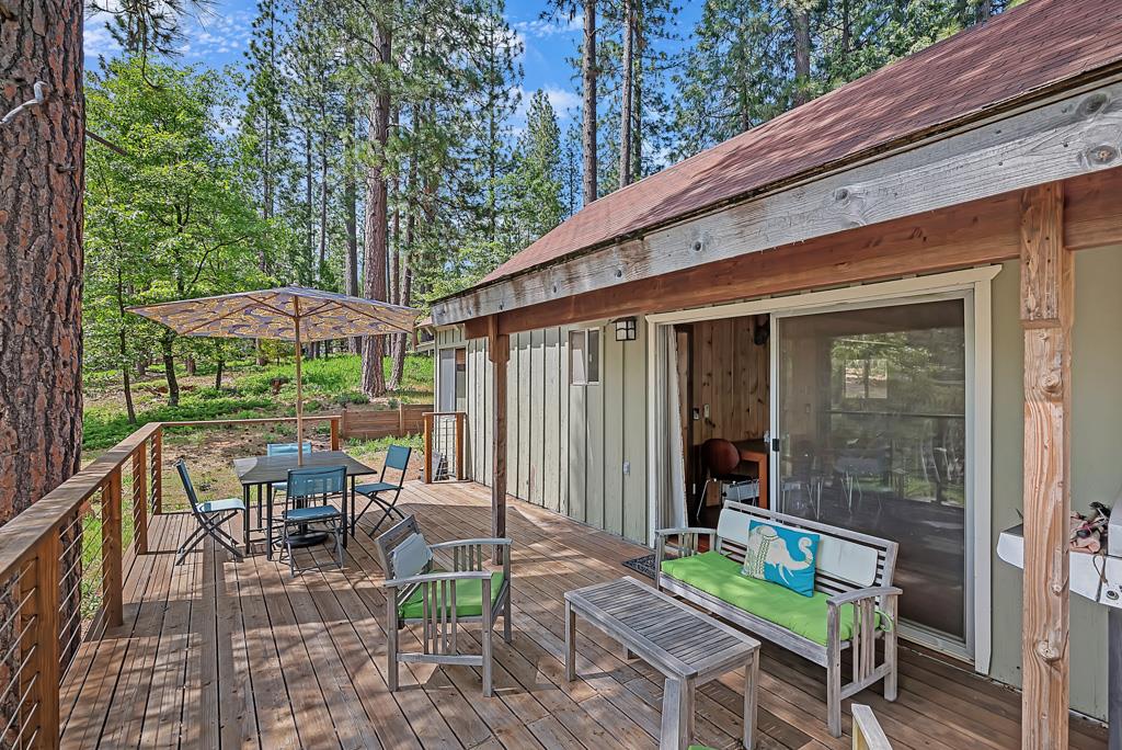 1753 Lightning Lane Arnold, CA 95223 - Photo 26 of 46 a view of a patio with a table and chairs under an umbrella with a small yard