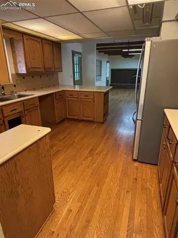 a kitchen with wooden floors and sink