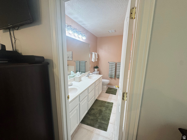 1976 River Bottom Road Springville, UT 84663 - Photo 21 of 45 Bathroom featuring a double vanity with ample counter space, white cabinetry, and two undermount sinks