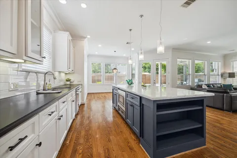 a kitchen with granite countertop counter space a sink stainless steel appliances and windows