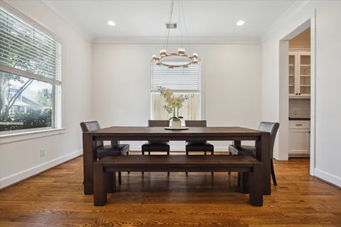 a view of a dining room with furniture window and wooden floor