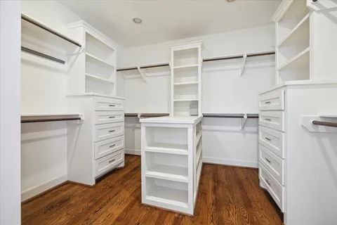 a view of walk in closet with empty racks