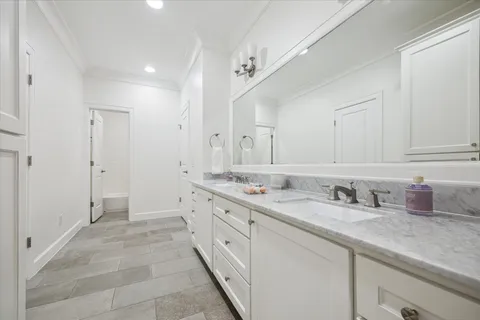 a bathroom with a granite countertop sink mirror and double