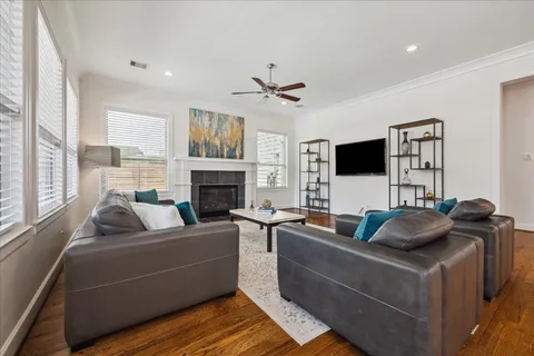 a living room with furniture a fireplace and a flat screen tv