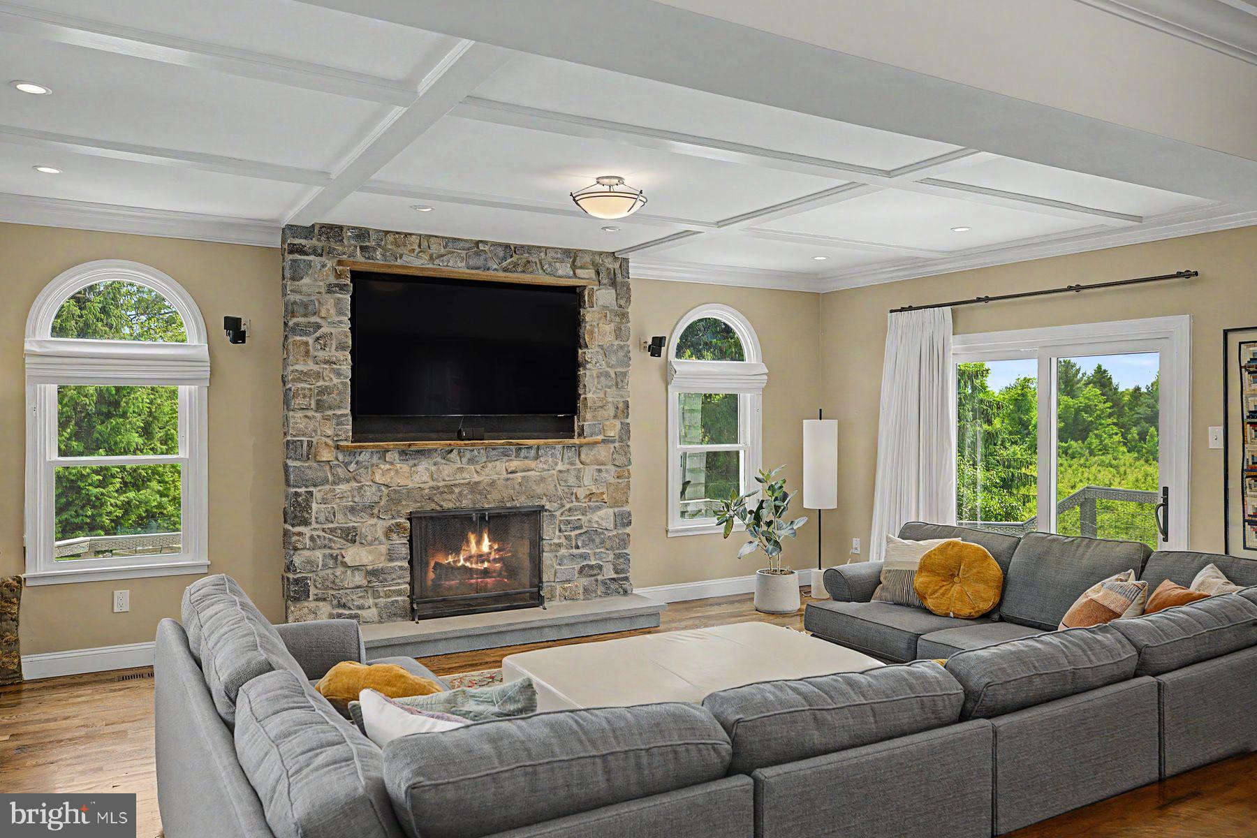 4009 Smoke Road Doylestown, PA 18902 - Photo 11 of 52 a living room with furniture a fireplace and a flat screen tv
