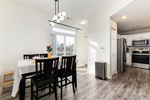 a view of a dining room with furniture window and wooden floor