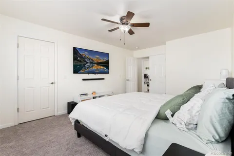 a bedroom with a bed and a chandelier