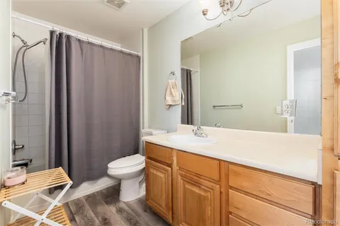 a spacious bathroom with a sink a toilet and shower