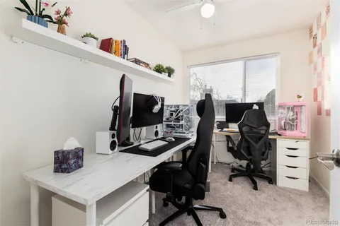 a view of a workspace with furniture and a window