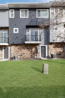 a brick house that has a small yard