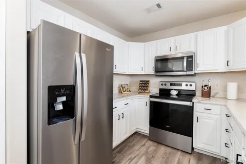 a kitchen with stainless steel appliances and refrigerator