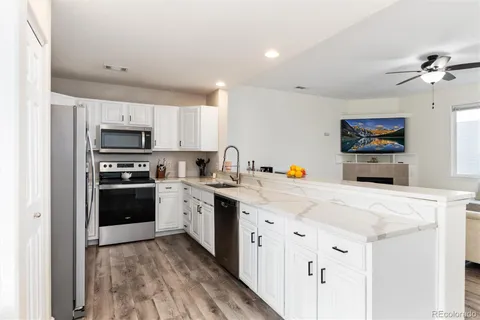 a kitchen with stainless steel appliances a stove sink microwave and cabinets