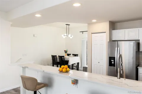 a kitchen with a refrigerator and a sink