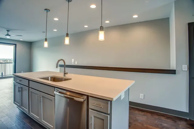 a kitchen with a sink and a refrigerator