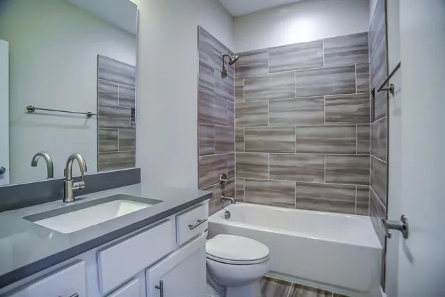 a bathroom with a sink a toilet and a bathtub