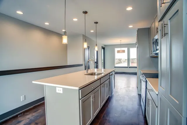a kitchen with a sink and a refrigerator