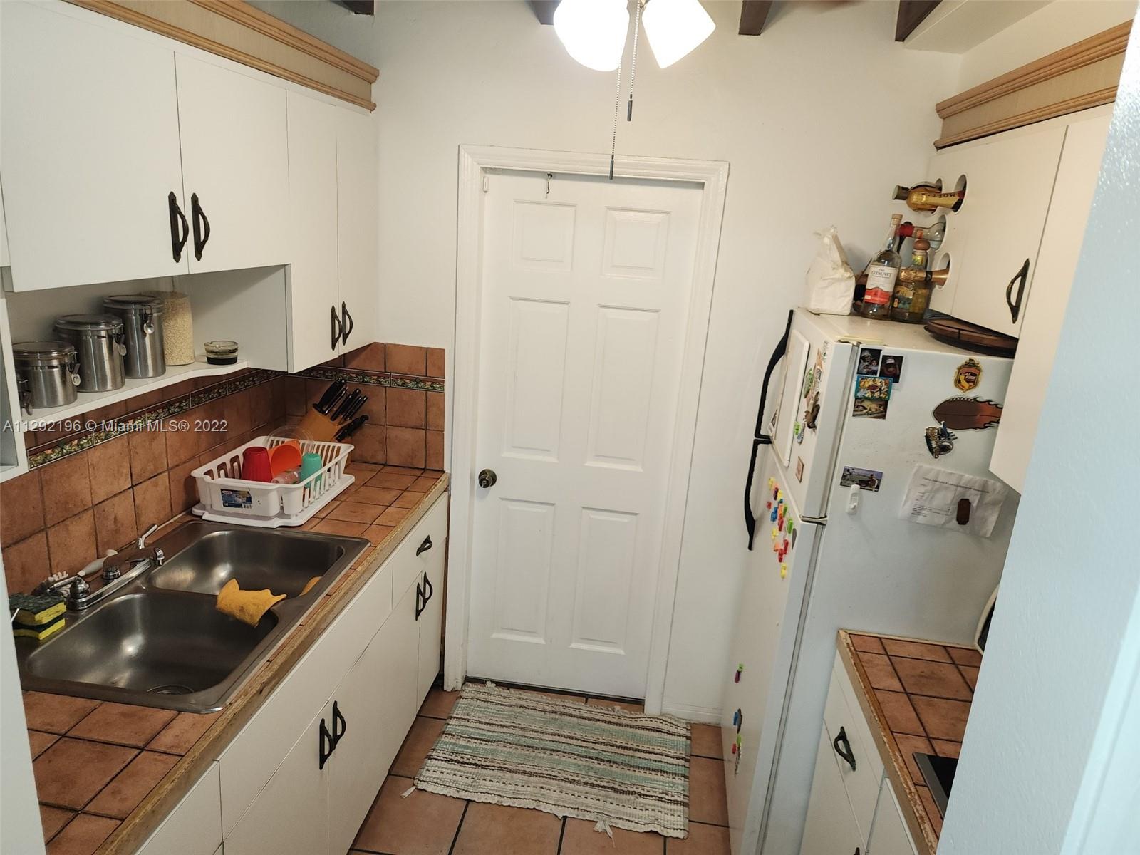 Tropical Estates Miami, FL 33165 - Photo 11 of 31 a kitchen with a sink and cabinets