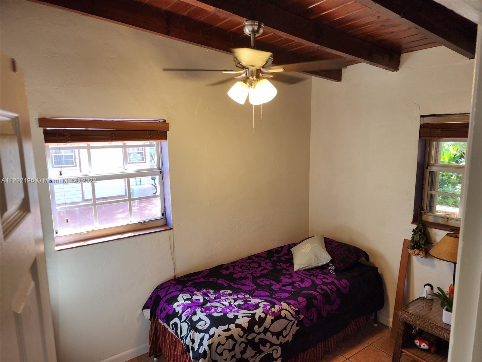 Tropical Estates Miami, FL 33165 - Photo 17 of 31 a bedroom with a bed and a window