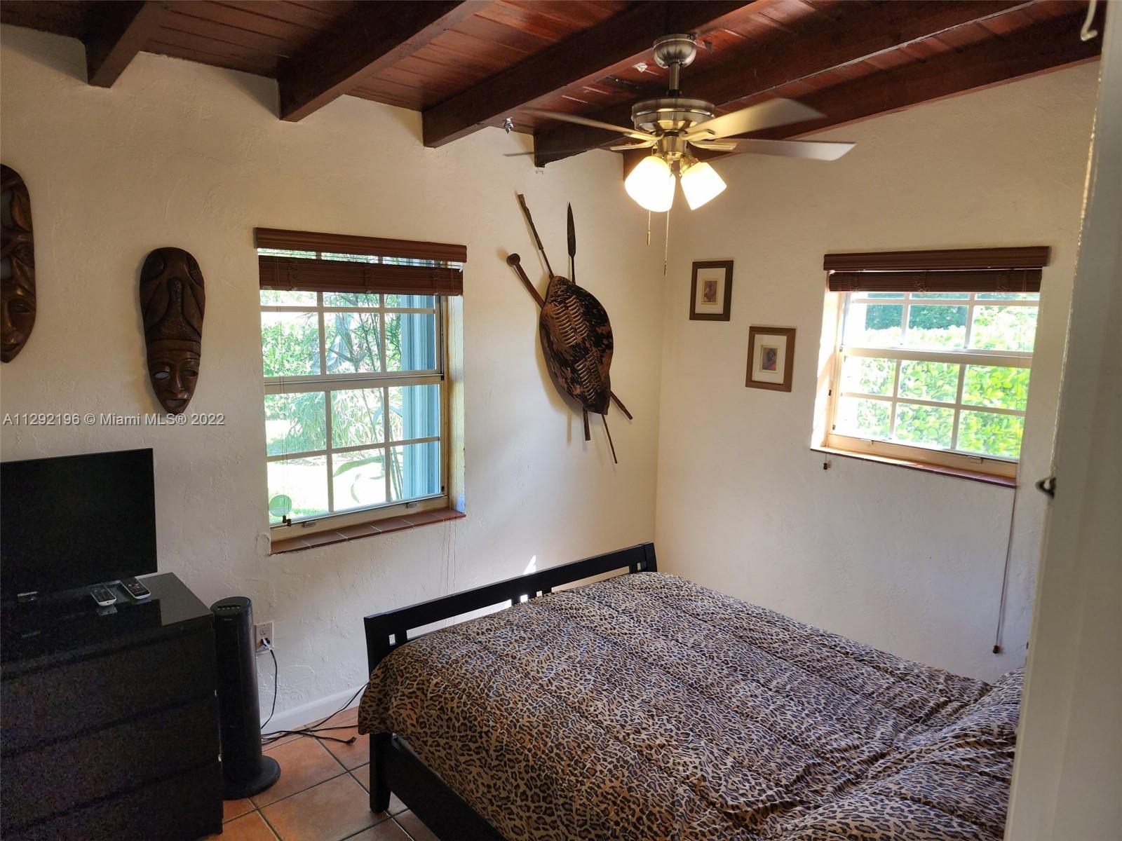 Tropical Estates Miami, FL 33165 - Photo 18 of 31 a bedroom with a bed and a flat screen tv