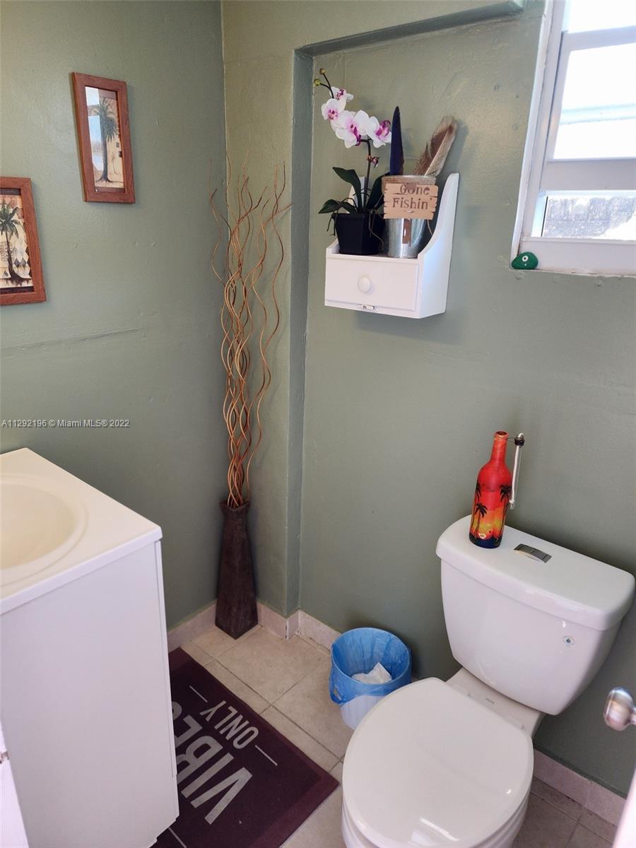 Tropical Estates Miami, FL 33165 - Photo 20 of 31 a bathroom with a sink a toilet and a window