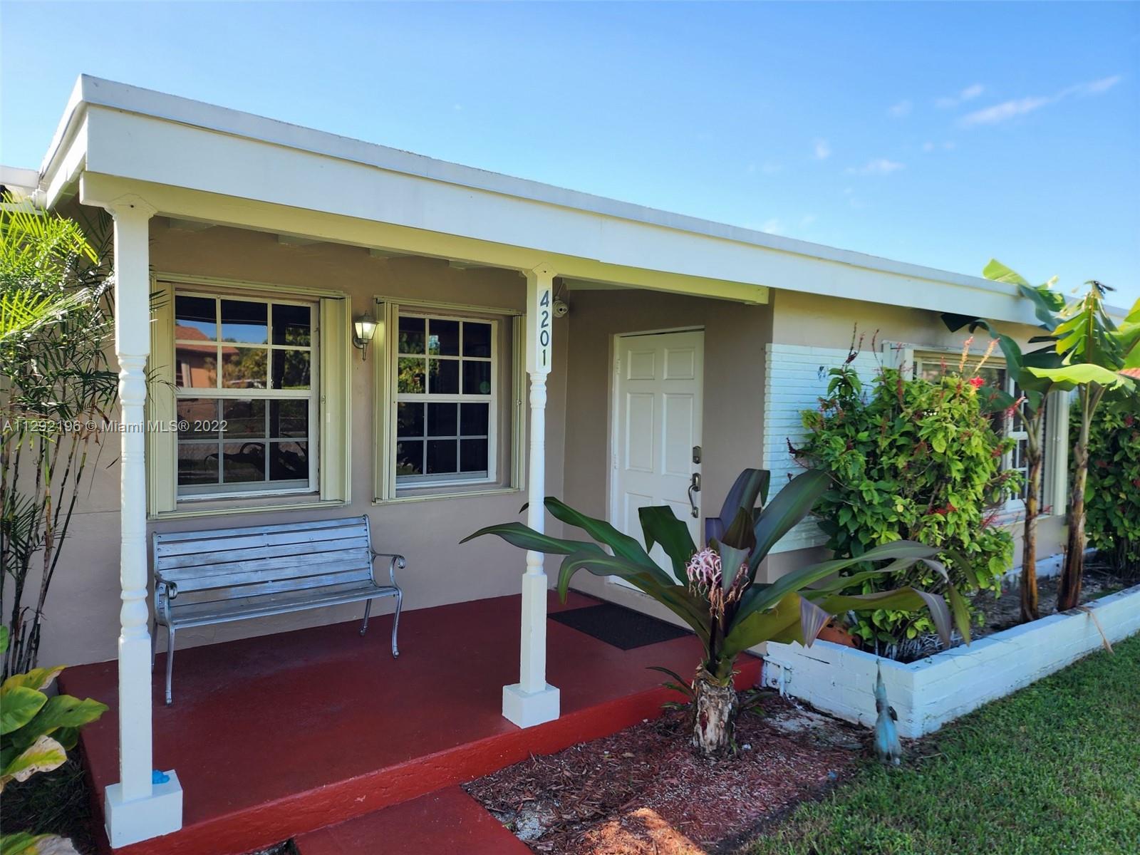 Tropical Estates Miami, FL 33165 - Photo 2 of 31 a potted plant sitting in front of a house