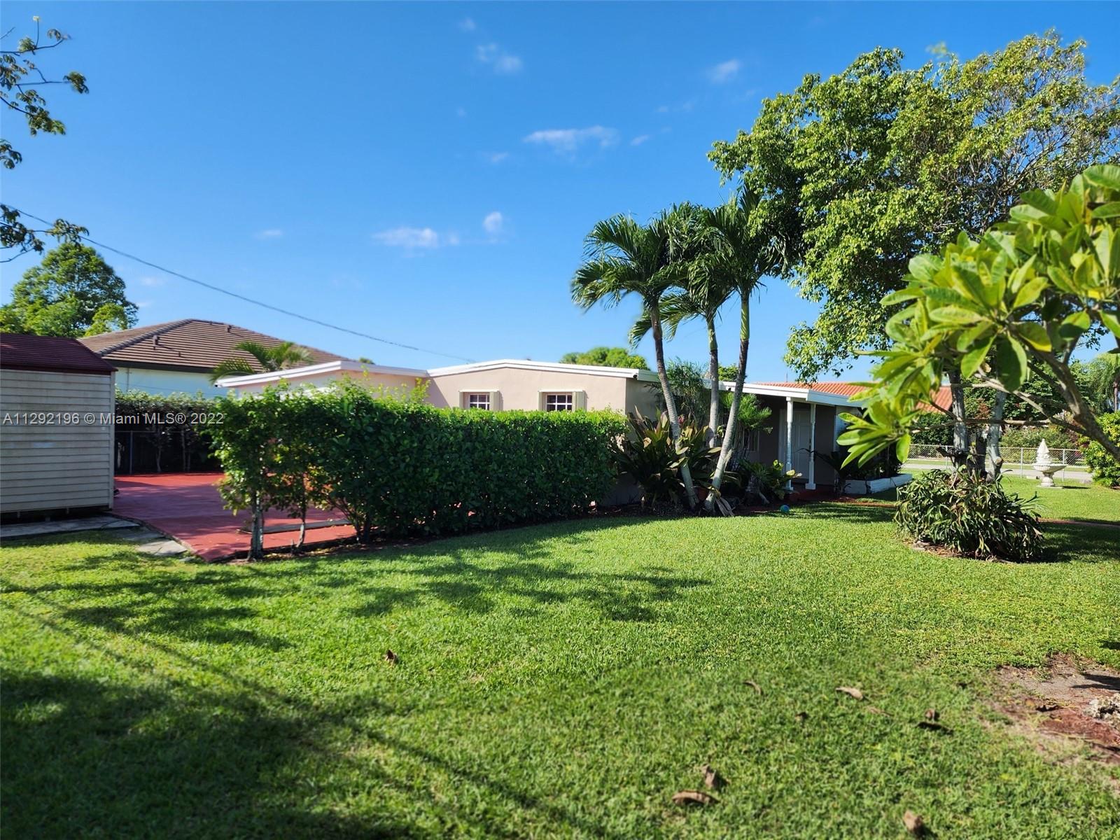 Tropical Estates Miami, FL 33165 - Photo 24 of 31 a view of a backyard with a garden