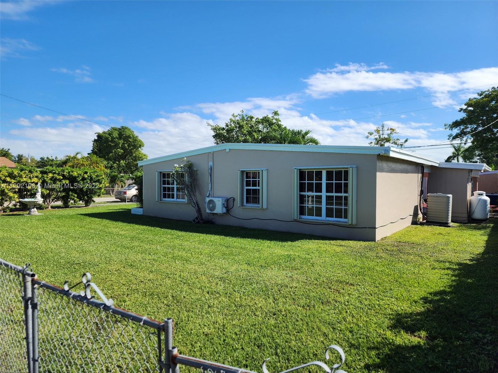 Tropical Estates Miami, FL 33165 - Photo 27 of 31 a view of a backyard with plants and a garden