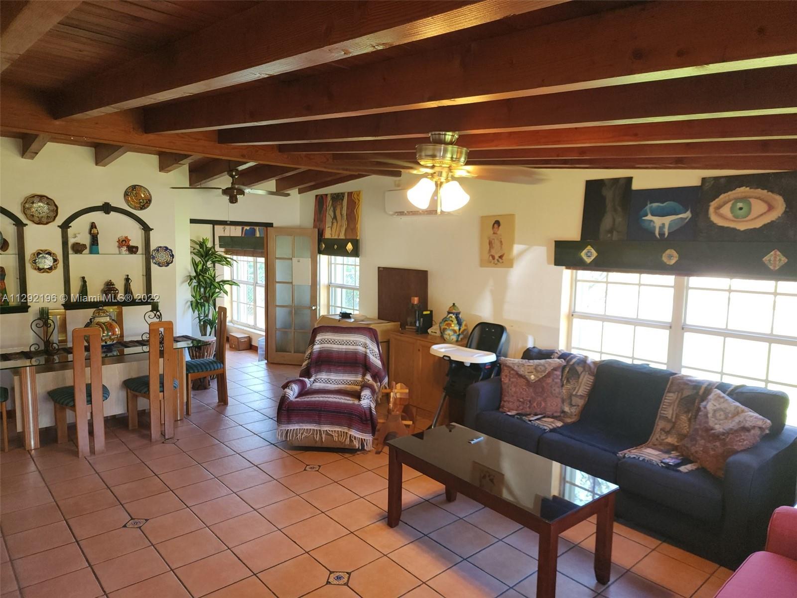 Tropical Estates Miami, FL 33165 - Photo 6 of 31 a living room with furniture and a window