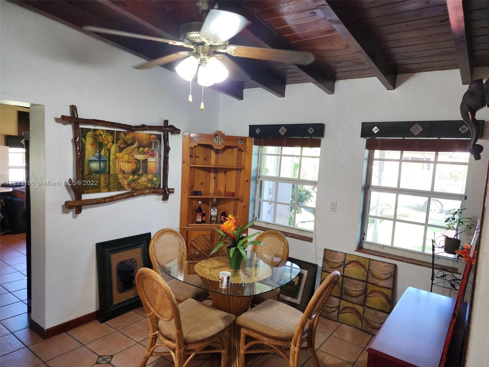 Tropical Estates Miami, FL 33165 - Photo 8 of 31 a dining room with furniture a flat screen tv and a large window