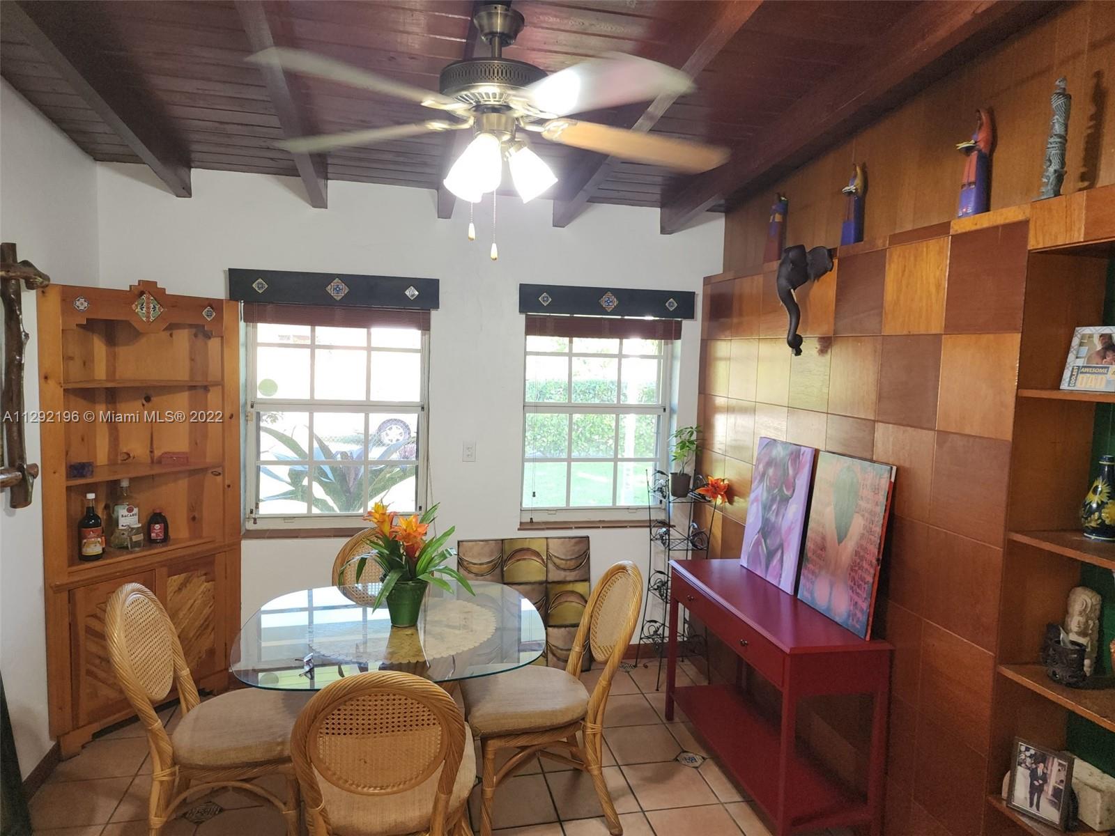 Tropical Estates Miami, FL 33165 - Photo 9 of 31 a dining room with furniture a chandelier and wooden floor