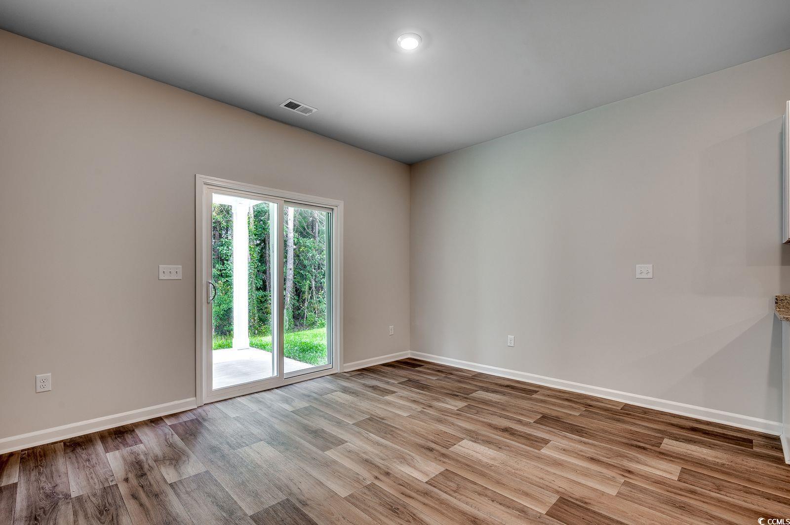 1004 Sentinel Court Little River, SC 29566 - Photo 10 of 31 Spare room featuring light wood-style floors and baseboards