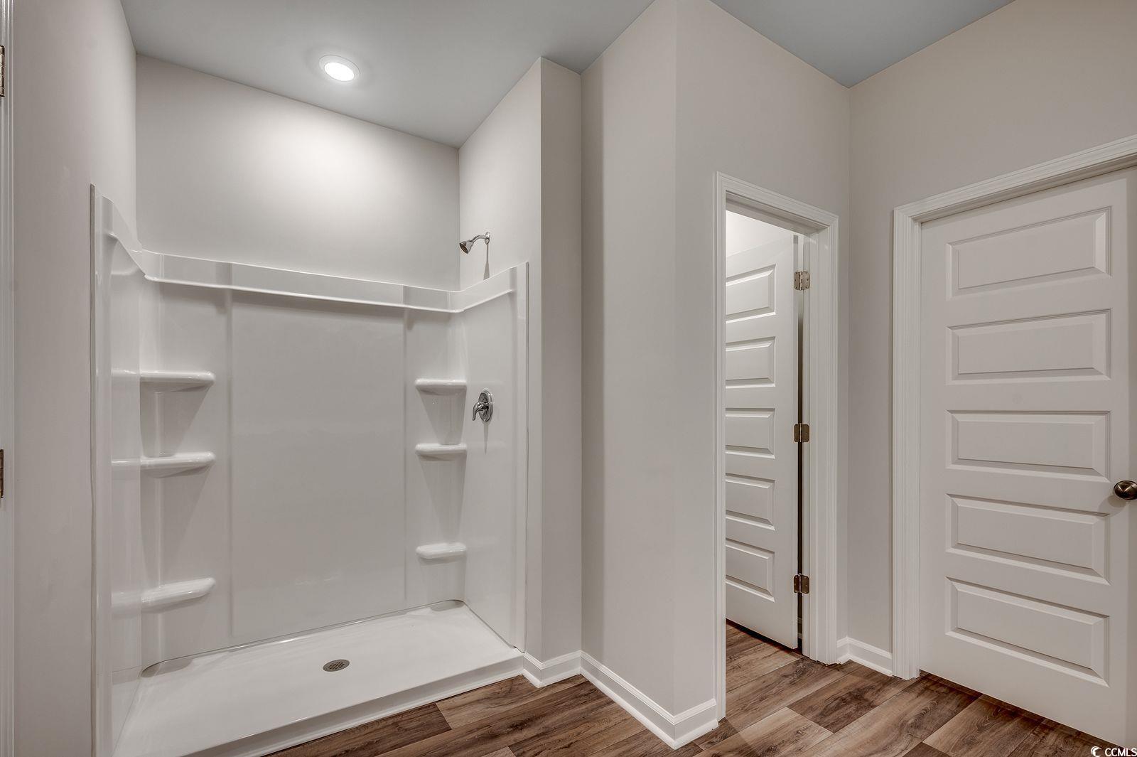 1004 Sentinel Court Little River, SC 29566 - Photo 14 of 31 Full bath featuring a shower stall and wood finished floors
