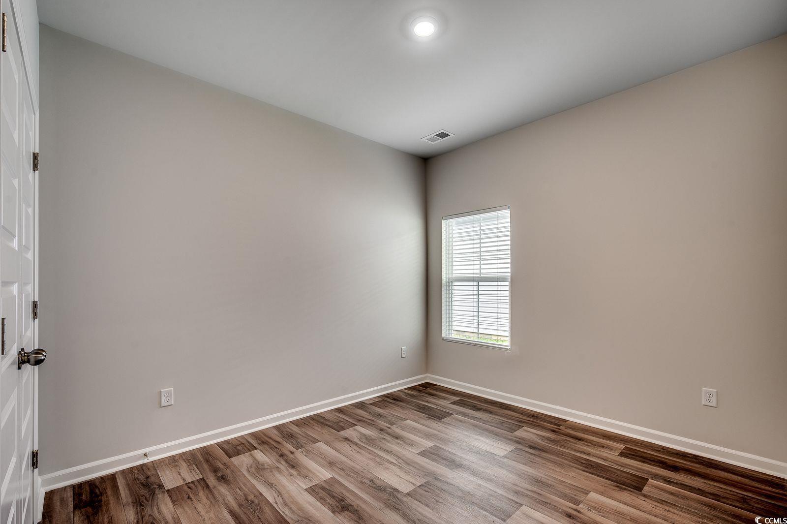 1004 Sentinel Court Little River, SC 29566 - Photo 18 of 31 Unfurnished room featuring wood finished floors and baseboards