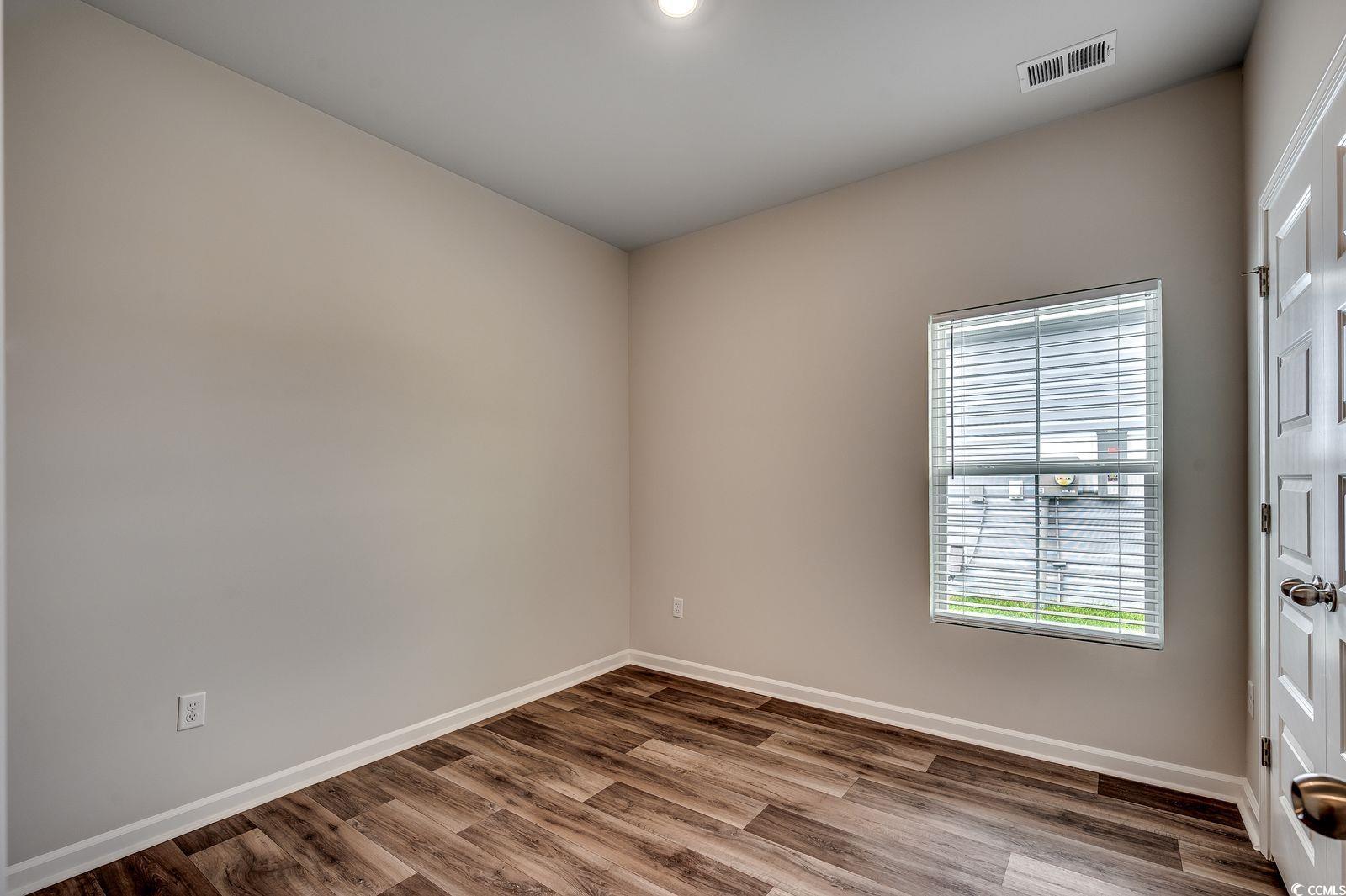 1004 Sentinel Court Little River, SC 29566 - Photo 19 of 31 Unfurnished room with wood finished floors and baseboards