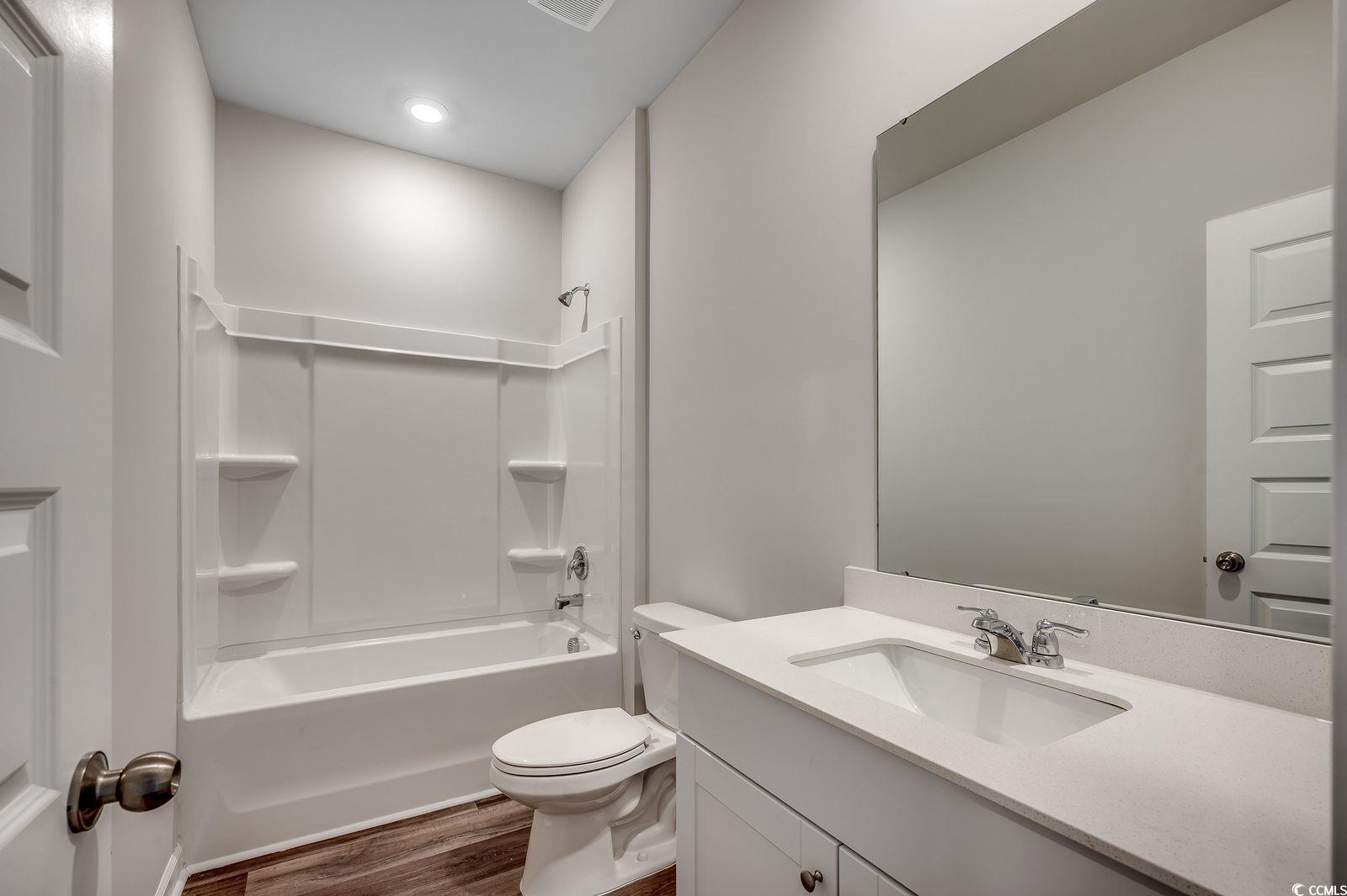 1004 Sentinel Court Little River, SC 29566 - Photo 20 of 31 Full bath featuring shower / tub combination, vanity, and dark wood-style floors