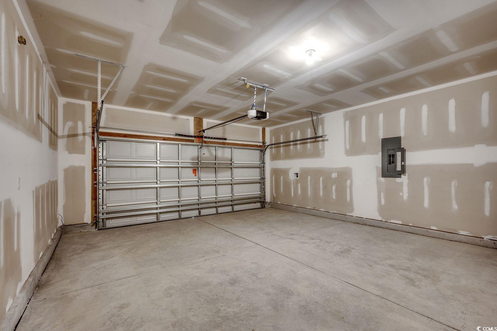 1004 Sentinel Court Little River, SC 29566 - Photo 22 of 31 Garage featuring electric panel and a garage door opener