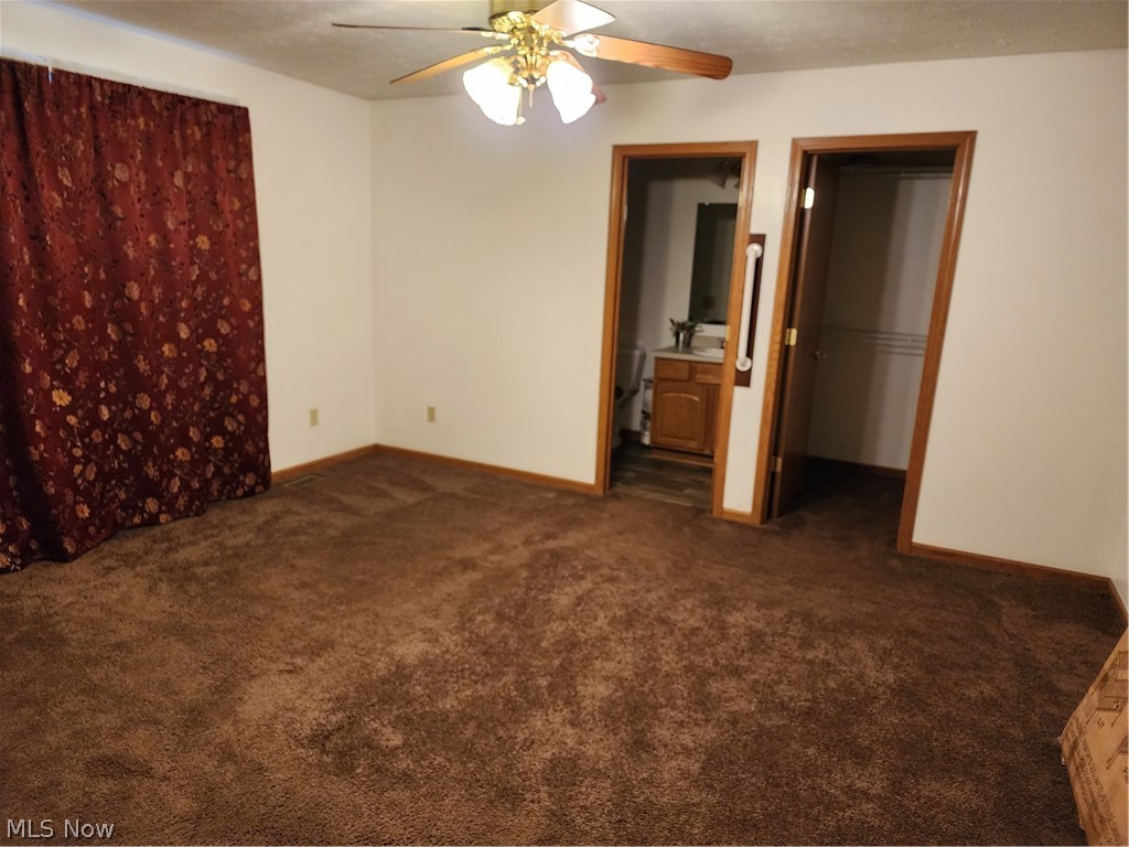 176 Overhill Road Youngstown, OH 44512 - Photo 10 of 20 Master bedroom featuring ensuite bathroom, dark carpet, and ceiling fan