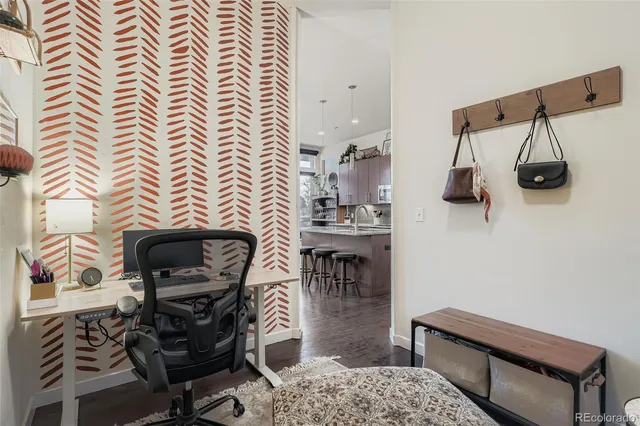 a bedroom with a bed a desk and chair