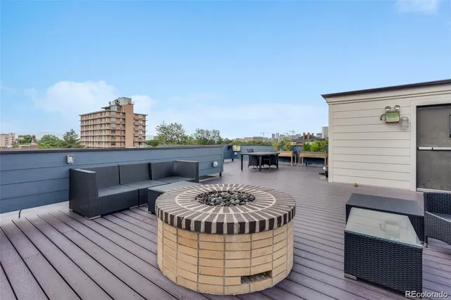 a view of a roof deck with furniture
