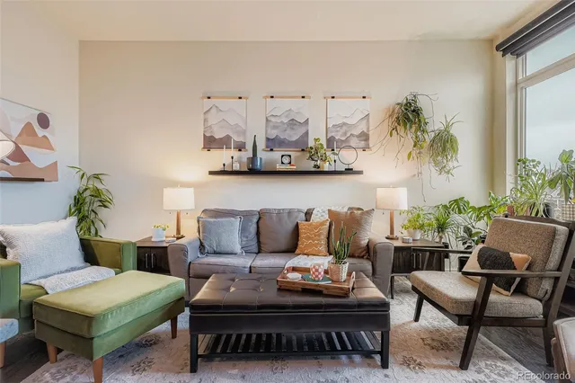 a living room with furniture and painting on the wall