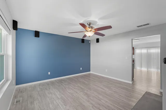 a view of an empty room with wooden floor