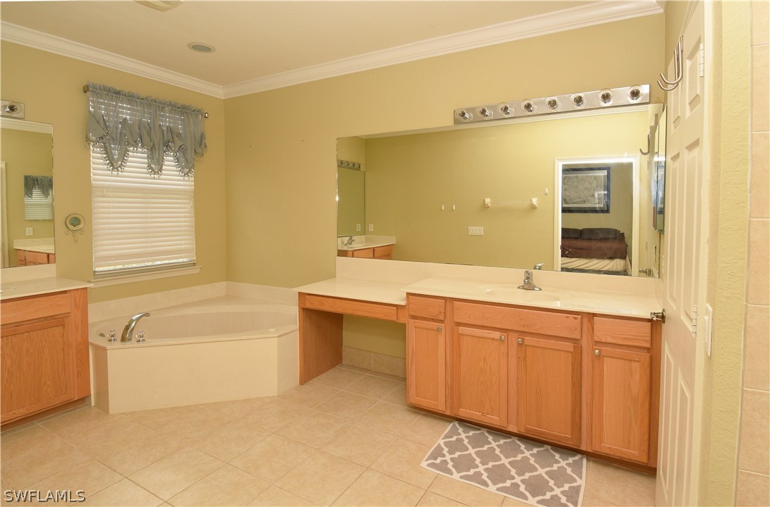 4002 Cherrybrook Loop Fort Myers, FL 33966 - Photo 21 of 35 a bathroom with a tub sink and mirror