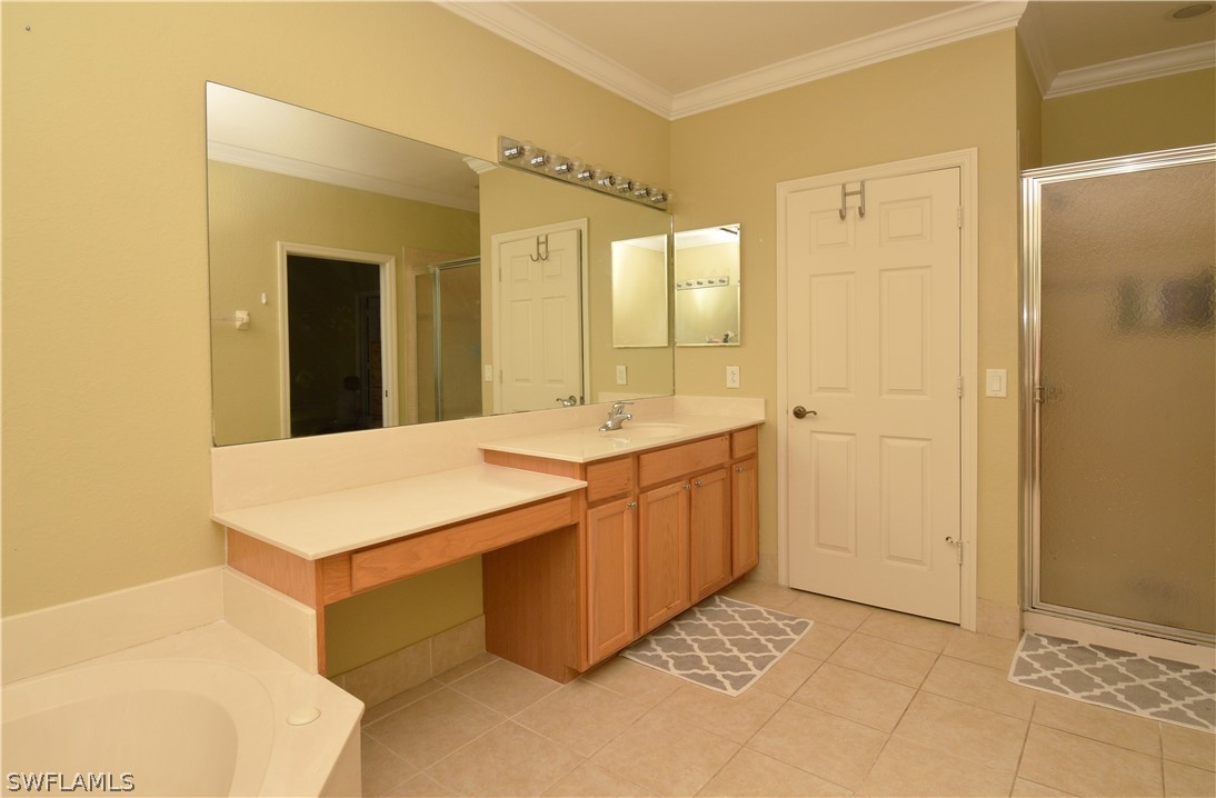 4002 Cherrybrook Loop Fort Myers, FL 33966 - Photo 22 of 35 a bathroom with a sink a mirror and a shower