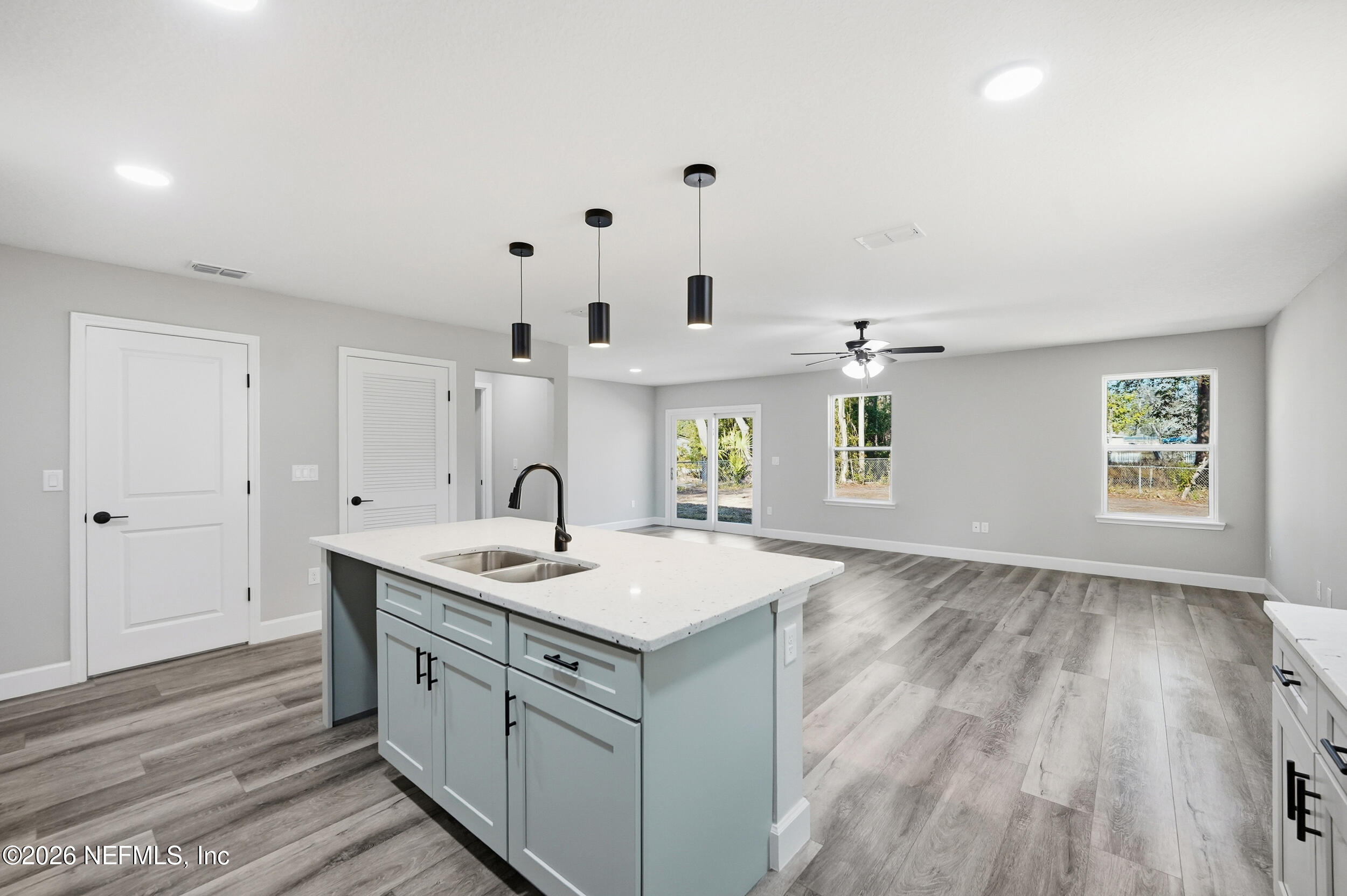 a bathroom with a granite countertop sink a toilet and a large mirror