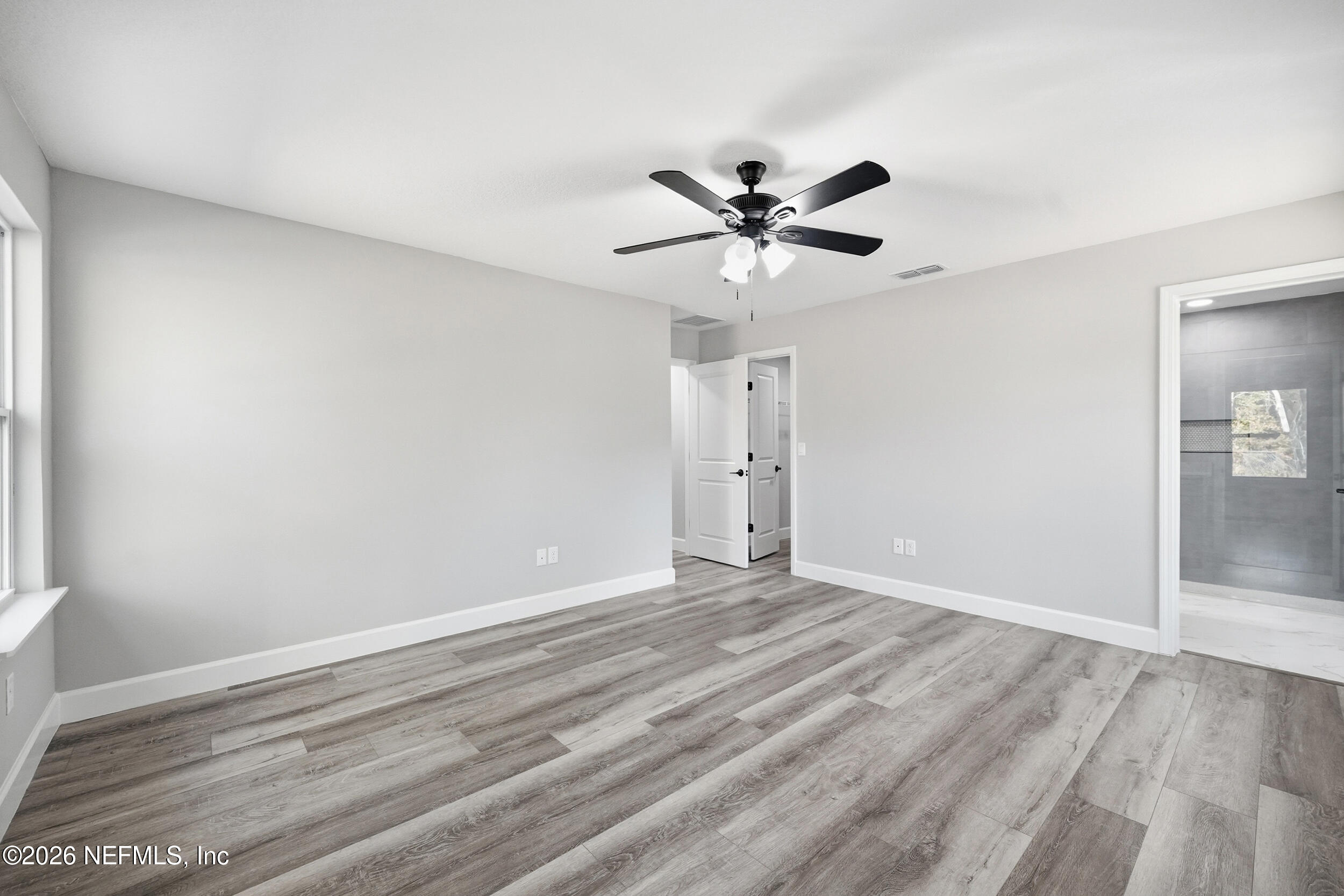 5259 Shenandoah Avenue Jacksonville, FL 32254 - Photo 13 of 51 a view of empty room with wooden floor and ceiling fan
