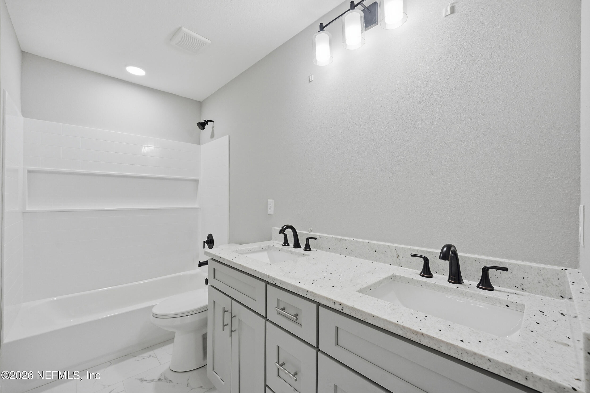 5259 Shenandoah Avenue Jacksonville, FL 32254 - Photo 20 of 51 a bathroom with a granite countertop sink a toilet and a bathtub