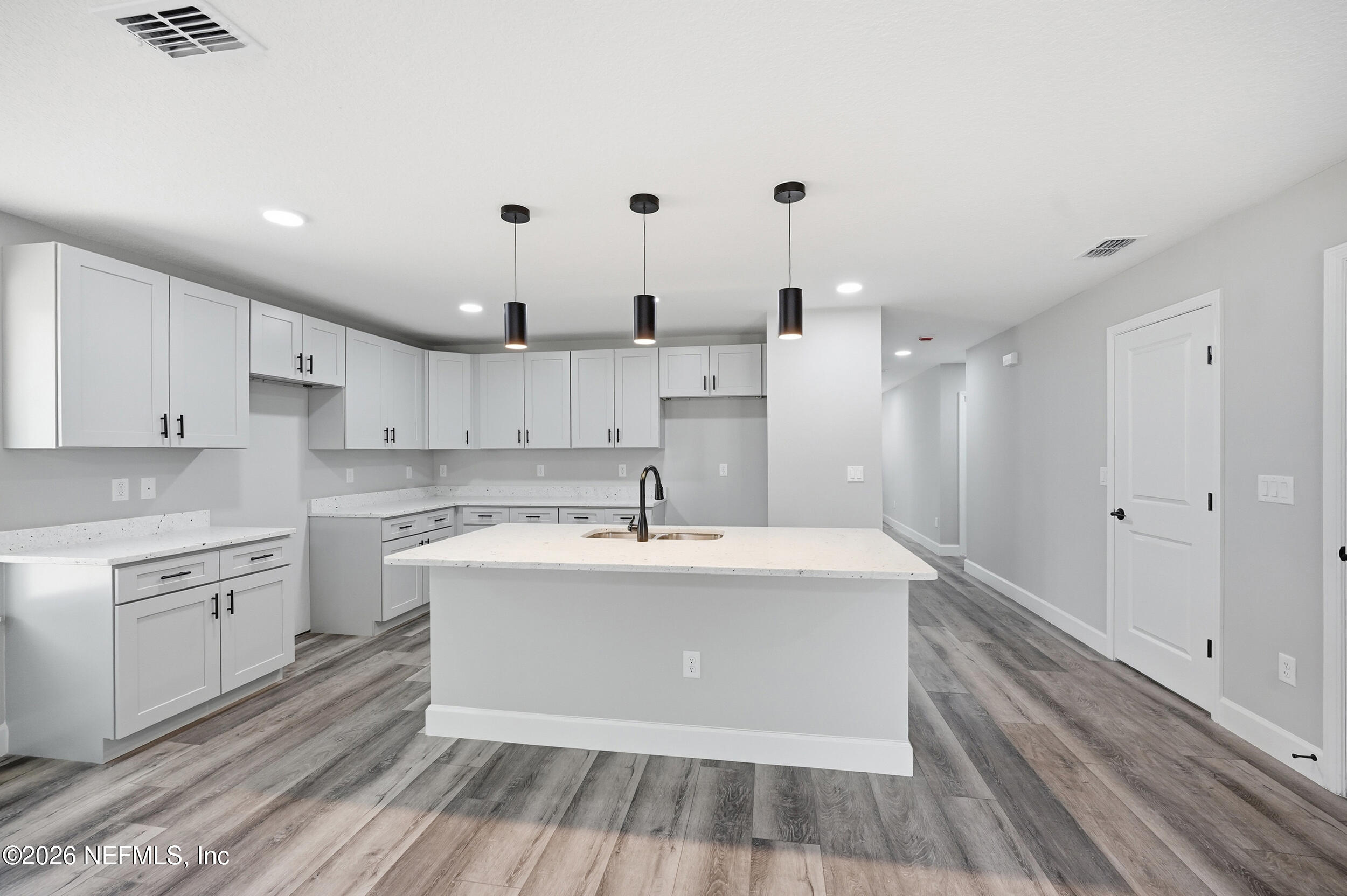 5259 Shenandoah Avenue Jacksonville, FL 32254 - Photo 4 of 51 a large white kitchen with kitchen island a sink stainless steel appliances and cabinets